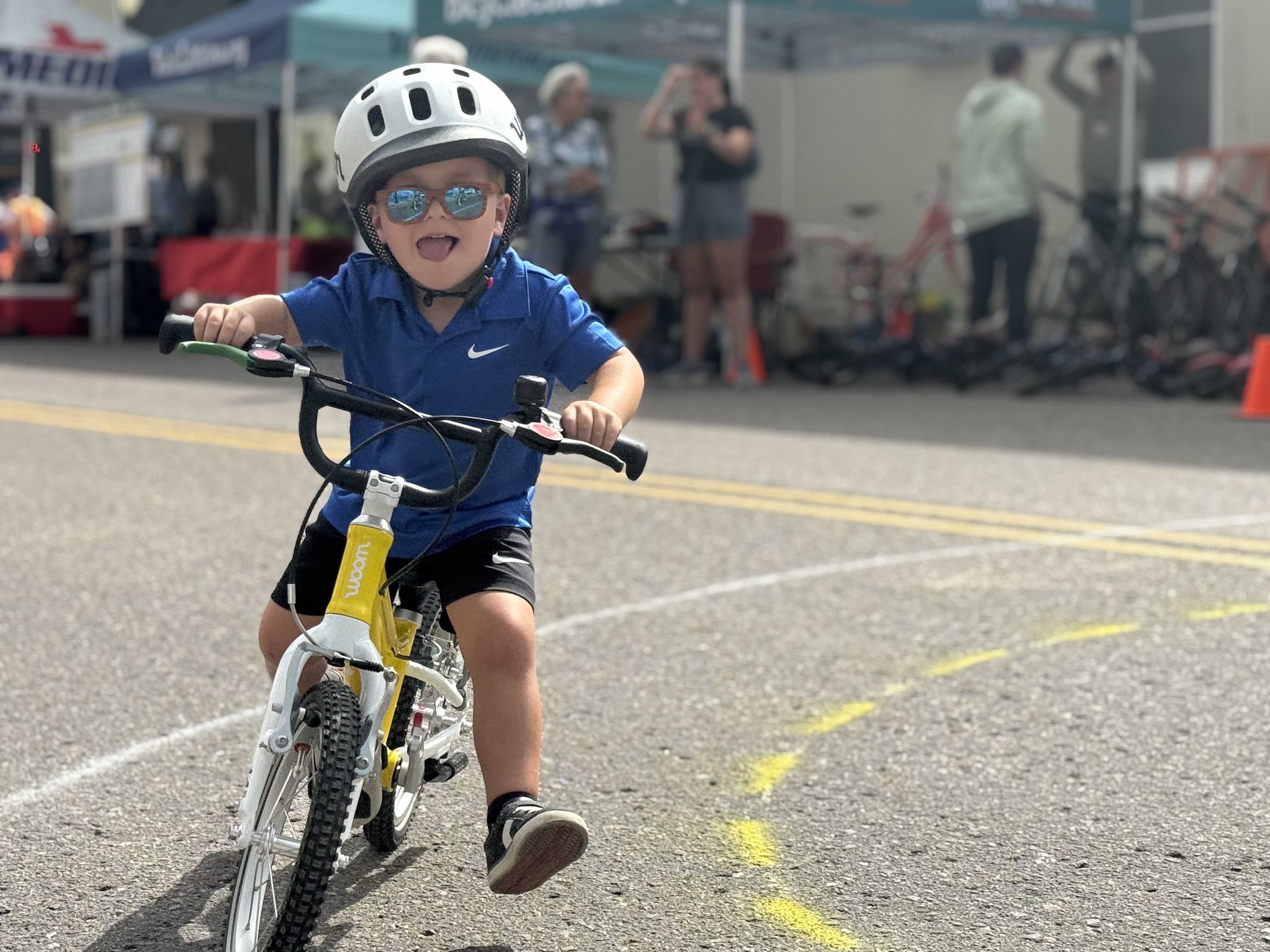 Kid smiling on a bicycle