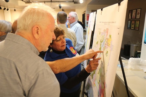 Littleton residents discussing the ULUC zoning map and the older, now repealed zoning map.
