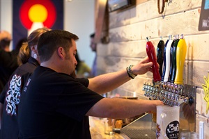 Man pouring beer on tap