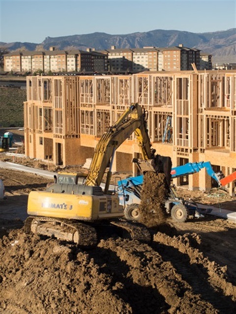 Littleton Commons under construction, showing a bulldozer moving earth and the frames of buildings behind it.